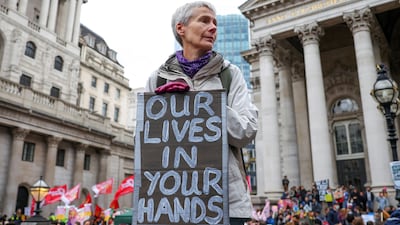 A demonstrator holds a banner during a climate protest in London. Reuters