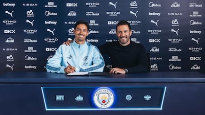 Tijjani Reijnders signs for Manchester City in the presence of City's director of football Hugo Viana. Photo: Manchester City FC