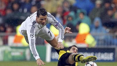 Cristiano Ronaldo, left, of Real Madrid falls over Henrikh Mkhitaryan of Borussia Dortmund during their Uefa Champions League quarter-final first leg match at Santiago Bernabeu stadium in Madrid on April 2, 2014. Javier Barbancho / Reuters