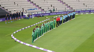 Cricketers and umpires observe a minute's silence for John Hume - a cricket fan - as play resumes behind closed doors following the outbreak of Covid-19 in Southampton on Tuesday. Reuters