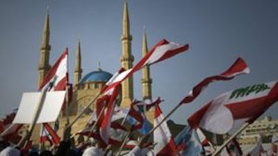 Demonstrators wave Lebanese flags near Mohammed Al-Amin mosque as they attend a rally to mark the 5th anniversary of former prime minister Rafiq Hariri's assassination in downtown Beirut on February 14, 2010.