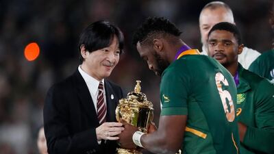 Rugby Union - Rugby World Cup - Final - England v South Africa - International Stadium Yokohama, Yokohama, Japan - South Africa's Siya Kolisi is presented the Webb Ellis trophy by Japan's Crown Prince Akishino after winning the World Cup Final REUTERS