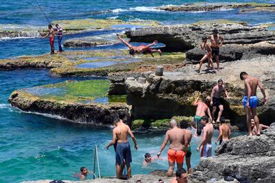 A youth jumps into the Mediterranean Sea at Al Manara ledge during a sunny day, in Beirut, Lebanon. EPA