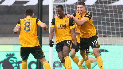 Wolves' Willy Boly, centre, celebrates with teammates after scoring his team's second goal. AFP