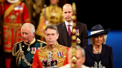 Prince Charles, Camilla, the Duchess of Cornwall, and Prince William follow the Imperial State Crown through the Royal Gallery for the State Opening of Parliament. Getty Images