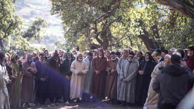 People pray during the funeral. AP Photo