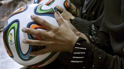 Employees conduct a final check to fix any cavities in the seams of balls inside the football factory that produces official match balls for the 2014 World Cup in Brazil, in Sialkot, Punjab province on May 16, 2014. It was when he felt the roar of the crowd at the 2006 World Cup in Germany that Pakistani factory owner Khawaja Akhtar first dreamt up a goal of his own: to manufacture the ball for the biggest football tournament on the planet. Last year he finally got his chance - but only 33 days to make it happen. Sara Farid / Reuters