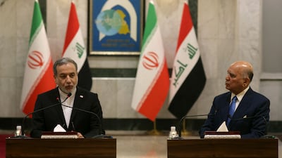 Abbas Araghchi, left, with Fuad Hussein in Baghdad. AFP