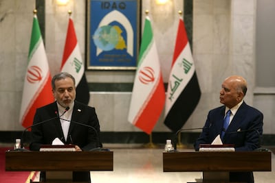 The Iranian Foreign Minister Abbas Aragchi, left, with his Iraqi counterpart Fuad Hussein. AFP