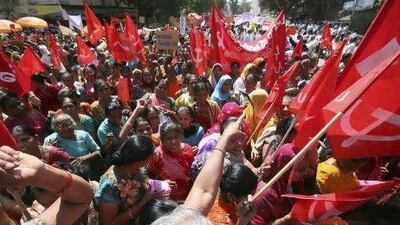 Workers march in the western Indian city of Ahmedabad yesterday during their one-day strike for better rights. Hundreds of thousands of them from several trade unions downed tools across India to express their anger at soaring prices and to back demands for a better deal.