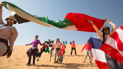 Participants wave the flags of their home countries during the five-day adventure. Courtesy Women’s Heritage Walk