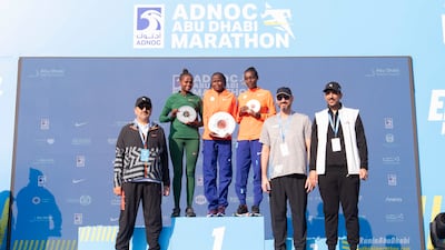 Adnoc Abu Dhabi Marathon women's race winner Brigid Kosgei, centre, with second-placed Hawi Feysa Gejia, left, and Sintayehu Dessi. All photos Ruel Pableo for The National