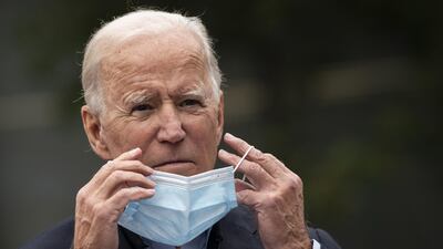 Joe Biden puts on a face mask while speaking in Chester, Pennsylvania, on October 26. Photo: Drew Angerer/Getty Images/AFP