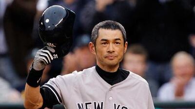 New York Yankees' Ichiro Suzuki doffs his helmet to the crowd.