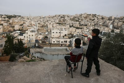 Palestinian boys look out over the Israeli-occupied West Bank city of Hebron. AFP