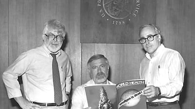 Three former directors of the Global Smallpox Eradication Programme: Dr J Donald Millar, Dr William H Foege and Dr J Michael Lane, with the 'World Health' magazine, 1980. Centres for Disease Control / Smith Collection / Gado/ Getty