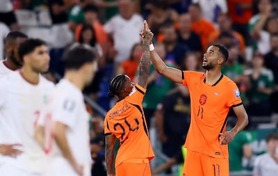 Cody Gakpo, right, points to the sky after scoring against Morocco. Reuters