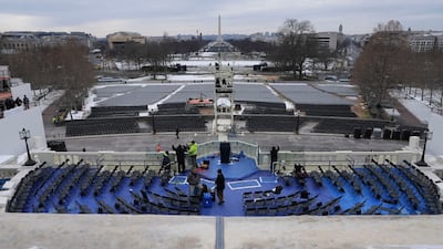 Workers prepare for the presidential inauguration parade in Washington, which will now take place indoors. Bloomberg