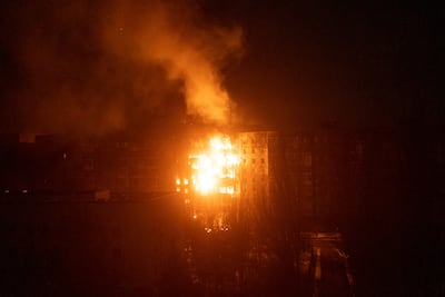 A fire burns at an apartment building after it was hit by shelling in Mariupol. AP Photo