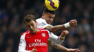 Mesut Ozil, bottom, has not been able to rise to the challenge enough for Arsenal. Eddie Keough / Reuters