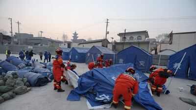 Rescue workers set up tents for quake survivors in Dahejia, Jishishan county. AFP