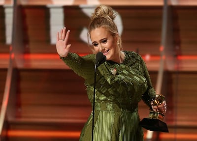 Adele waves to singer Beyonce who is in the audience as she and co-song writer Greg Kurstin accept the Grammy for Song of the Year for "Hello" at the 59th Annual Grammy Awards in Los Angeles, California, US, on February 12, 2017. Reuters
