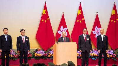 In Hong Kong, Matthew Cheung, Hong Kong's chief secretary, center, speaks during a ceremony to mark the 70th anniversary of the People's Republic of China. Bloomberg
