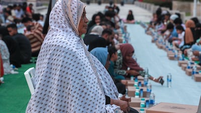 Worshippers wait for the start of iftar at the mosque. Victor Besa / The National