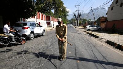 An Indian policeman lays concertina wire near the residence of Jammu Kashmir National Conference (JKNC) President and Member of Parliament of India, Farooq Abdullah at Gupkar Road in Srinagar, India, 16 September 2019. EPA