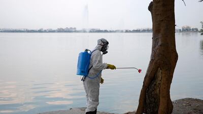 A member from Disaster Response Force (DRF) of Telangana State, wearing a protective gear sprays disinfectant on a public place amid concerns over the spread of the COVID-19 novel coronavirus, in Hyderabad. AFP