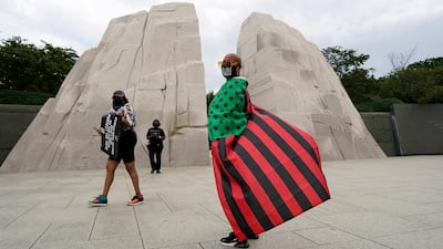 Terri Biley, of Los Angeles, stands at The Martin Luther King, Jr. Memorial during the March on Washington in Washington, on the 57th anniversary of the Rev. Martin Luther King Jr.'s "I Have A Dream" speech. AP Photo