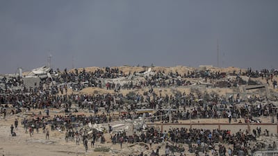 Internally displaced Palestinians wait for aid lorries near a food distribution point in Zikim, northern Gaza Strip. EPA