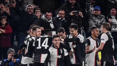 Juventus' Argentine forward Paulo Dybala (C) celebrates with Ronaldo and teamates after scoring. AFP