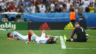 England players Joe Hart, right, Dele Alli, centre, and Gary Cahill slump to the ground after the defeat to Iceland. Alex Livesey / Getty Images