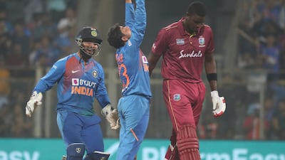 India's Kuldeep Yadav, center, celebrates the dismissal of West Indies Jason Holder during the third Twenty20 in Mumbai on Wednesday. AP