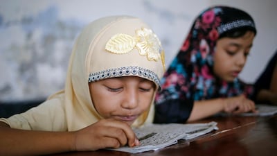Bangladeshi Muslim girls read the holy Koran at the Madrasa in Dhaka. EPA