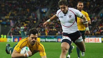 Adam Ashley-Cooper dives over for one of his three tries during Australia's win over the United States.