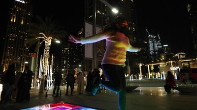 Visitors interact with the piece 'Al Saha'. Chris Whiteoak / The National