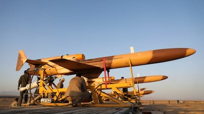 Mechanics work on drones ahead of their flight. Reuters
