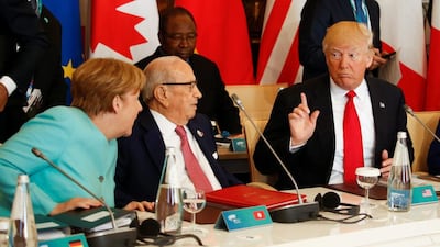 US President Donald Trump making his point to German Chancellor Angela Merkel and Tunisia's President Beji Caid Essebsi at the G7 Summit expanded session in Taormina, Sicily, Italy on May 27, 2017. Jonathan Ernst / Reuters
