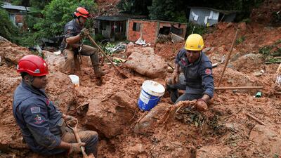 Firefighters dig for victims of a mudslide, where five people died and four remain missing according to the fire department, in Morro do Macaco Molhado (wet monkey hill) in Guaruja, Sao Paulo state, Brazil. Reuters