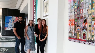 From left, the Greek artist Yiannis Roussakis with Kathryn Ryan, Emily Gordon, and Julia Ibbini – members of the No White Walls art collective. Christopher Pike / The National