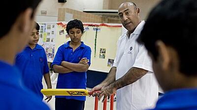 The former Pakistan Test player Mudassar Nazar teaches a group of children from the Al Khaleej School in Dubai.