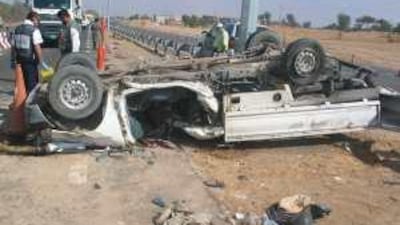 The overturned pick-up truck on the Jebel Ali to Lahbab road on Tuesday. Two men died in the accident.