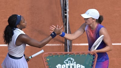 Iga Swiatek shakes hands with Coco Gauff after the match on Court Philippe-Chatrier. AFP