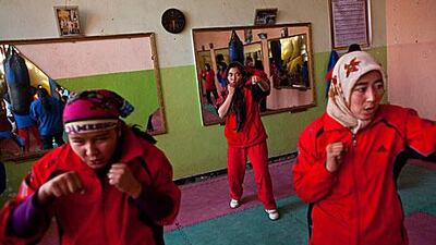 Afghan women train inside the Ghazi Stadium in Kabul. Female boxers are unusual in most countries, but especially in Afghanistan, where two sisters have been threatened they will be kidnaped if they continue to pracitse the sport.