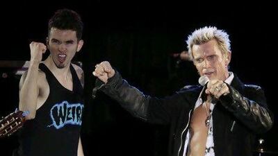 The Seattle musician Michael Henrichsen, left, convinced the rock star Billy Idol to play at his birthday party Friday. Ted S Warren / AP Photo