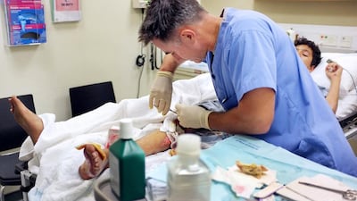 A patient is treated at the emergency room at Sheikh Khalifa Medical City. Delores Johnson / The National
