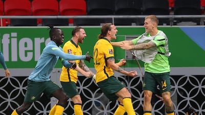 Australia's midfielder Jackson Irvine, second right, celebrates with teammates after scoring the opener. AFP
