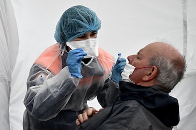 A health worker tests fans at the Tour de France. AFP